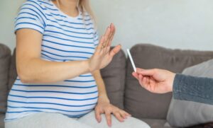 The pregnant woman refuses to smoke. Selective focus.